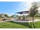 play area with modern equipment and shade structure next to open green space in a Gathering-friendly community at 6807 Satin Silver Ct, North Las Vegas, NV 89086