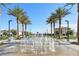 Attractive water feature with palm trees lining a walkway, surrounded by benches in a residential area at 6807 Satin Silver Ct, North Las Vegas, NV 89086