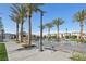 Inviting community water feature with palm trees, benches, and a clubhouse in a vibrant outdoor setting at 6807 Satin Silver Ct, North Las Vegas, NV 89086