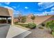 Landscaped backyard with artificial turf, desert landscaping, and covered patio at 741 Flowing Meadow Dr, Henderson, NV 89014