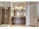 Bathroom featuring dual sink vanity, decorative lighting, and glass shower at 741 Flowing Meadow Dr, Henderson, NV 89014