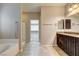 A bathroom features a soaking tub, glass shower, double vanity, and large walk-in closet at 741 Flowing Meadow Dr, Henderson, NV 89014