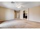 Spacious carpeted bedroom featuring neutral tones, ceiling fan, and adjacent bath at 741 Flowing Meadow Dr, Henderson, NV 89014