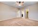 Spacious bedroom with a ceiling fan, neutral walls, and multiple doorways at 741 Flowing Meadow Dr, Henderson, NV 89014
