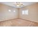 A bedroom features two windows, a ceiling fan, and neutral carpet at 741 Flowing Meadow Dr, Henderson, NV 89014
