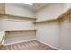 Walk-in closet with carpeted flooring and wooden shelves on three walls at 741 Flowing Meadow Dr, Henderson, NV 89014