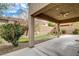A serene covered patio overlooks a well-maintained backyard with artificial turf and desert landscaping at 741 Flowing Meadow Dr, Henderson, NV 89014