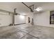 Spacious garage featuring epoxy floor, storage cabinets, and water heater at 741 Flowing Meadow Dr, Henderson, NV 89014