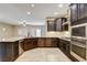Gourmet kitchen features granite countertops, stainless steel appliances, and a stylish tile backsplash at 741 Flowing Meadow Dr, Henderson, NV 89014