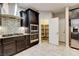 Close-up of a modern kitchen with a gas range, dark cabinets and tile backsplash at 741 Flowing Meadow Dr, Henderson, NV 89014
