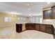 Modern kitchen design, featuring a large granite island, stainless steel appliances, and tile flooring at 741 Flowing Meadow Dr, Henderson, NV 89014