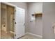 Laundry room features a utility sink, open doorway to the bathroom, and washer/dryer hookups at 741 Flowing Meadow Dr, Henderson, NV 89014