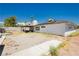 This backyard features a covered patio, perfect for outdoor dining, xeriscaping, and solar panels at 7701 Pheasant Ln, Las Vegas, NV 89145