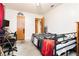 Modest bedroom with basic furnishings and a minimalistic design at 7701 Pheasant Ln, Las Vegas, NV 89145