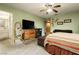 Spacious bedroom boasting comfortable carpet flooring, ceiling fan, and natural light at 7701 Pheasant Ln, Las Vegas, NV 89145