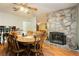 Open-concept dining room with a stone fireplace and wooden furniture at 7701 Pheasant Ln, Las Vegas, NV 89145