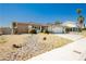 Single story home with desert landscaping, two car garage, and driveway with room for multiple vehicles at 7701 Pheasant Ln, Las Vegas, NV 89145