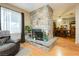 Stone fireplace with view of dining area at 7701 Pheasant Ln, Las Vegas, NV 89145