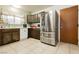Kitchen with stainless steel refrigerator and tile flooring at 7701 Pheasant Ln, Las Vegas, NV 89145
