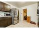 Well-lit kitchen featuring stainless steel appliances and tile flooring at 7701 Pheasant Ln, Las Vegas, NV 89145
