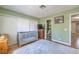 Bedroom with hardwood floors, neutral walls, crib, and ensuite bath at 7961 Lions Rock Way # 202, Las Vegas, NV 89128