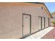 Building exterior with three separate units identified with individual numbered doors at 7961 Lions Rock Way # 202, Las Vegas, NV 89128