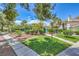 Beautiful community landscaping featuring mature trees, green grass, and well maintained walkways at 7961 Lions Rock Way # 202, Las Vegas, NV 89128