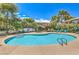 Community pool with lounge chairs and beautifully landscaped grounds for relaxation and enjoyment at 7961 Lions Rock Way # 202, Las Vegas, NV 89128