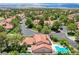 Aerial view showcasing the pool, trees, and tile roofs within the Spanish Trail community at 7988 Pinnacle Peak Ave, Las Vegas, NV 89113