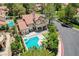 Stunning aerial view of the home with a private pool, lush landscaping, and a charming neighborhood at 7988 Pinnacle Peak Ave, Las Vegas, NV 89113