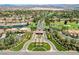 Aerial view of a golf community featuring manicured landscaping, a serene lake, and numerous homes at 7988 Pinnacle Peak Ave, Las Vegas, NV 89113