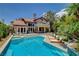 Backyard featuring a sparkling pool, lounge chairs, and lush landscaping, perfect for outdoor enjoyment and relaxation at 7988 Pinnacle Peak Ave, Las Vegas, NV 89113