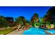 Inviting backyard oasis with a large pool, lush greenery, and comfortable lounge chairs for relaxation at 7988 Pinnacle Peak Ave, Las Vegas, NV 89113
