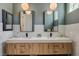 Modern bathroom featuring a double vanity with white countertop and unique tile backsplash at 7988 Pinnacle Peak Ave, Las Vegas, NV 89113