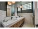 Stylish bathroom featuring a double vanity with white countertop and unique tile details at 7988 Pinnacle Peak Ave, Las Vegas, NV 89113