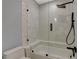 Bathroom featuring shower over tub with stylish tiling and glass shower screen at 7988 Pinnacle Peak Ave, Las Vegas, NV 89113