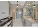 Bathroom with dual vanities, marble floors, glass shower, and ensuite entrance at 7988 Pinnacle Peak Ave, Las Vegas, NV 89113