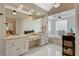Bathroom with marble floors, dual vanities, and a freestanding soaking tub at 7988 Pinnacle Peak Ave, Las Vegas, NV 89113