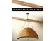 A wicker pendant lamp is hung from vaulted ceilings with decorative wood beams at 7988 Pinnacle Peak Ave, Las Vegas, NV 89113