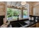 Kitchen sink with a view of the backyard with pool and putting green at 7988 Pinnacle Peak Ave, Las Vegas, NV 89113