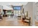 Bright, open-concept living room featuring hardwood floors and seamless flow to the dining area at 7988 Pinnacle Peak Ave, Las Vegas, NV 89113
