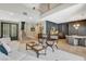 Well-lit living area featuring comfortable seating, an staircase, and contemporary decor at 7988 Pinnacle Peak Ave, Las Vegas, NV 89113