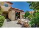 Charming outdoor patio with comfortable seating, a modern fire pit, and lush landscaping at 7988 Pinnacle Peak Ave, Las Vegas, NV 89113