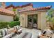 Inviting patio with a modern fire pit and seating, framed by the home's architecture and mature landscaping at 7988 Pinnacle Peak Ave, Las Vegas, NV 89113