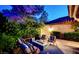 Cozy outdoor patio area with comfortable seating, a modern fire pit, and lush landscaping, creating a relaxing retreat at 7988 Pinnacle Peak Ave, Las Vegas, NV 89113