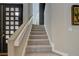 Bright stairway features carpeted steps, with glass-block window and modern front door at 7988 Pinnacle Peak Ave, Las Vegas, NV 89113