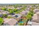 Aerial view of a home in a community with a pool, upper deck, solar panels, and desert landscaping at 8029 Flambeau St, Las Vegas, NV 89131