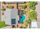 Aerial view of the home showing the backyard pool, upper deck, solar panels, and outdoor furniture at 8029 Flambeau St, Las Vegas, NV 89131