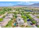 Aerial view of a desert community with multiple homes, trees, and a property with a private pool at 8029 Flambeau St, Las Vegas, NV 89131