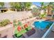 Aerial view of landscaped backyard with pool, outdoor seating, and perimeter lighting at 8029 Flambeau St, Las Vegas, NV 89131